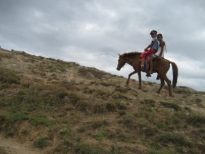 a young korean tourist and his young horse wrangler